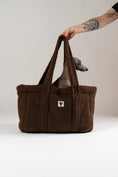 Load image into Gallery viewer, Karma Hund Teddy Shopper in Braun – luxuriöse, weiche Hundetasche aus Teddy-Stoff, mit einem italienischen Windspiel als Beispiel für Nutzung als Reisebett.